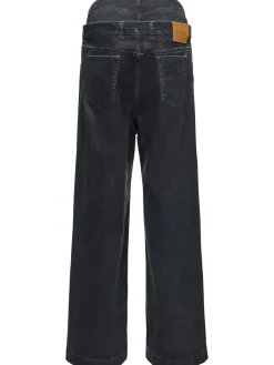 Jeans a gamba larga in tela spalmata